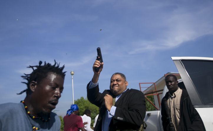 23 de septiembre: El senador haitiano Ralph Fethiere dispara una pistola al aire para dispersar a manifestantes frente al edificio del Parlamento del país. El fotógrafo de Associated Press, Dieu-Nalio Chery, resultó herido durante la conmoción. Las escenas caóticas siguieron a las recientes protestas por la escasez de combustible y alimentos, informó Reuters. Haití ha estado luchando con apagones y el aumento de los precios del combustible, lo que provocó la ira de la gente contra el gobierno. Dieu-Nalio Chery / AP