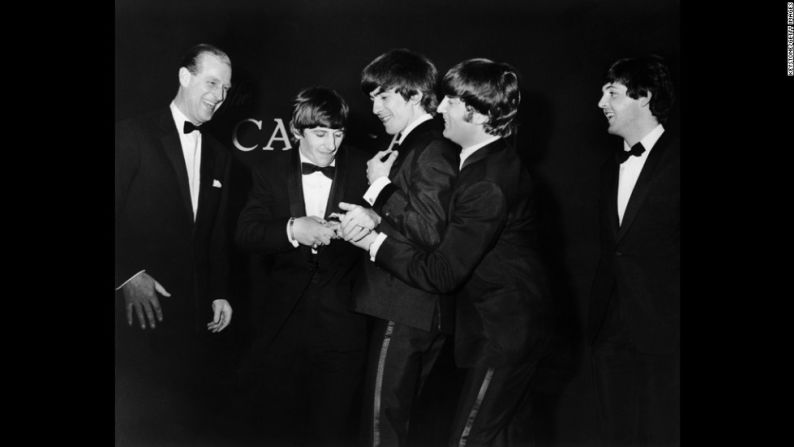 El príncipe Felipe se ríe mientras los Beatles pelean por el Premio Carl Alan que presentó a la banda en marzo de 1964.