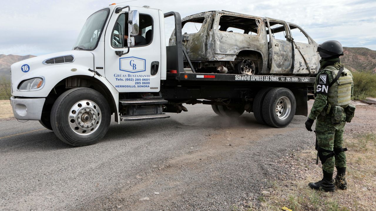 A worker lifts to the tow truck the burnt van where five of the nine members of the Mexican-American LeBaron family were killed, in the Sonora mountain range, Mexico, on November 6, 2019. - Mexican authorities said Wednesday they believe a drug cartel called "La Linea" was responsible for the murder of the three women and six children, saying the massacre was committed with American-made ammunition. Eight other children managed to escape, six of them wounded. (Photo by Herika Martinez / AFP)