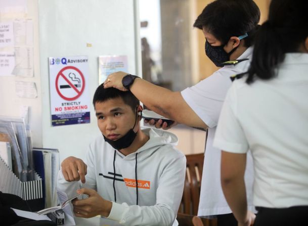 Un funcionario de cuarentena mide la temperatura de un pasajero chino en el aeropuerto internacional de Manila, Filipinas.