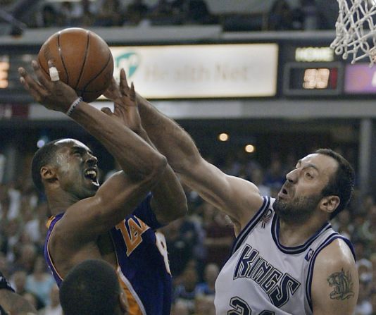 Vlade Divac, No. 21 de los Sacramento Kings, salta por el balón contra Bryant durante el cuarto juego de las Semifinales de la Conferencia Oeste en el Arco Arena el 13 de mayo de 2001, en Sacramento, California.