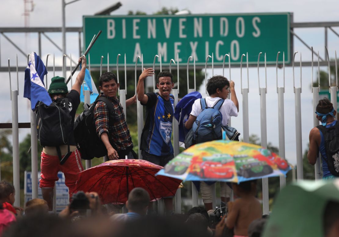 CIUDAD TECUN UMAN, GUATEMALA - OCTOBER 19:  Members of the migrant caravan climb atop a gate during a clash with Mexican riot police on the border between Mexico and Guatemala on October 19, 2018 in Ciudad Tecun Uman, Guatemala. A clash occurred when the caravan of thousands of migrants tried to enter Mexico, crossing over the international bridge after pushing past Guatemalan security forces. The caravan pried open the gate into Mexico but were pushed back by Mexican riot police. Some immigrants threw stones at police who then fired tear gas into the crowd.