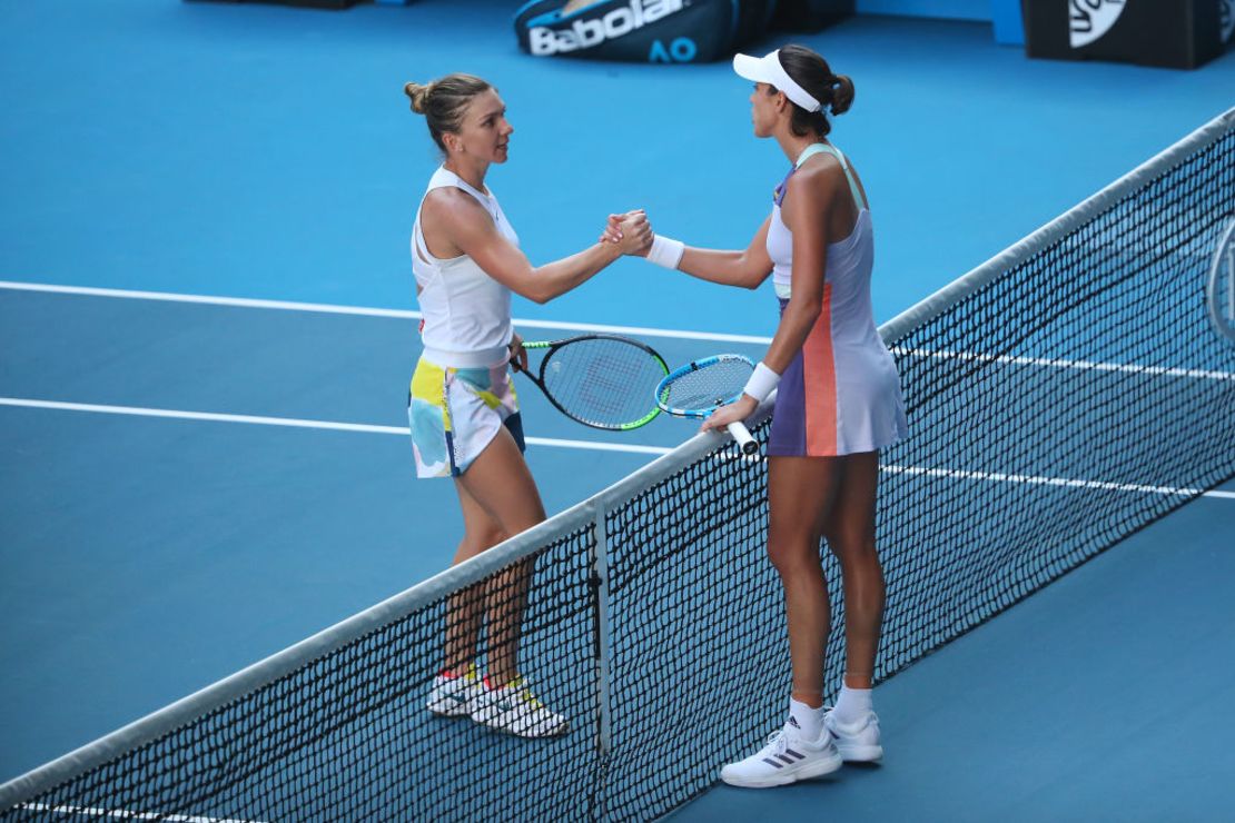 MELBOURNE, AUSTRALIA - JANUARY 30: Garbine Muguruza of Spain shakes hands with Simona Halep of Romania after their Women's Singles Semifinal match on day eleven of the 2020 Australian Open at Melbourne Park on January 30, 2020 in Melbourne, Australia.