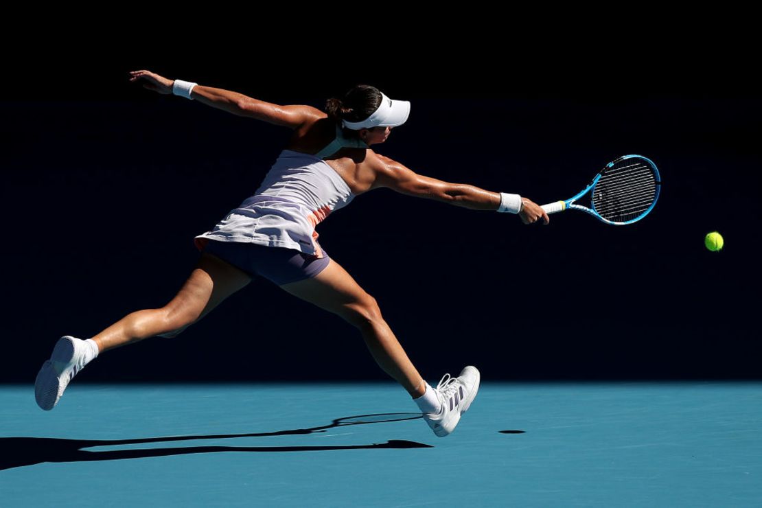 MELBOURNE, AUSTRALIA - JANUARY 30: Garbine Muguruza of Spain plays a backhand during her Women's Singles Semifinal match against Simona Halep of Romania on day eleven of the 2020 Australian Open at Melbourne Park on January 30, 2020 in Melbourne, Australia.