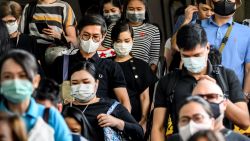 People wearing protective facemasks leave the city commuter train station in Bangkok on January 31, 2020. - The World Health Organization declared a global emergency over the new coronavirus, as China reported on January 31 the death toll had climbed to 213 with nearly 10,000 infections. (Photo by Mladen ANTONOV / AFP)