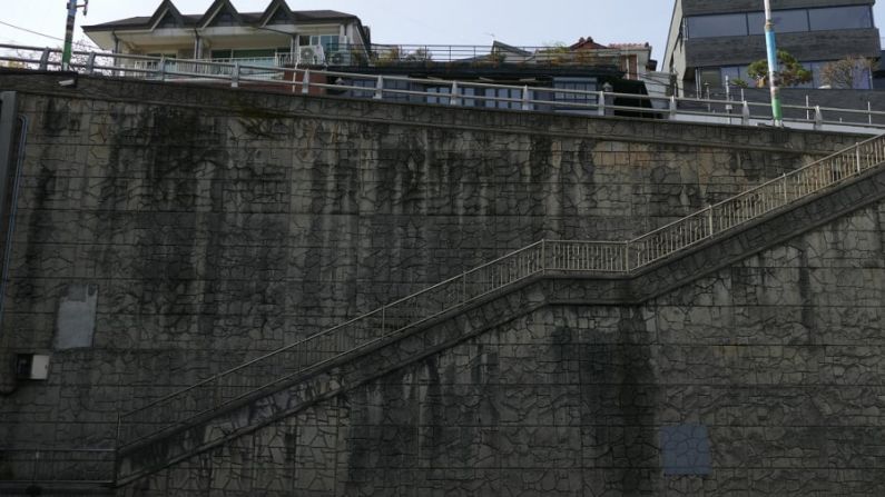 Escalera al túnel de Jahamun: es una de las escenas más importantes y desgarradoras de la película. Los Kim corren enloquecidos desde la casa de los Park y descienden por esta larga escalera bajo la lluvia torrencial hacia el túnel Jahamun de Seúl. Organización de turismo de Seúl