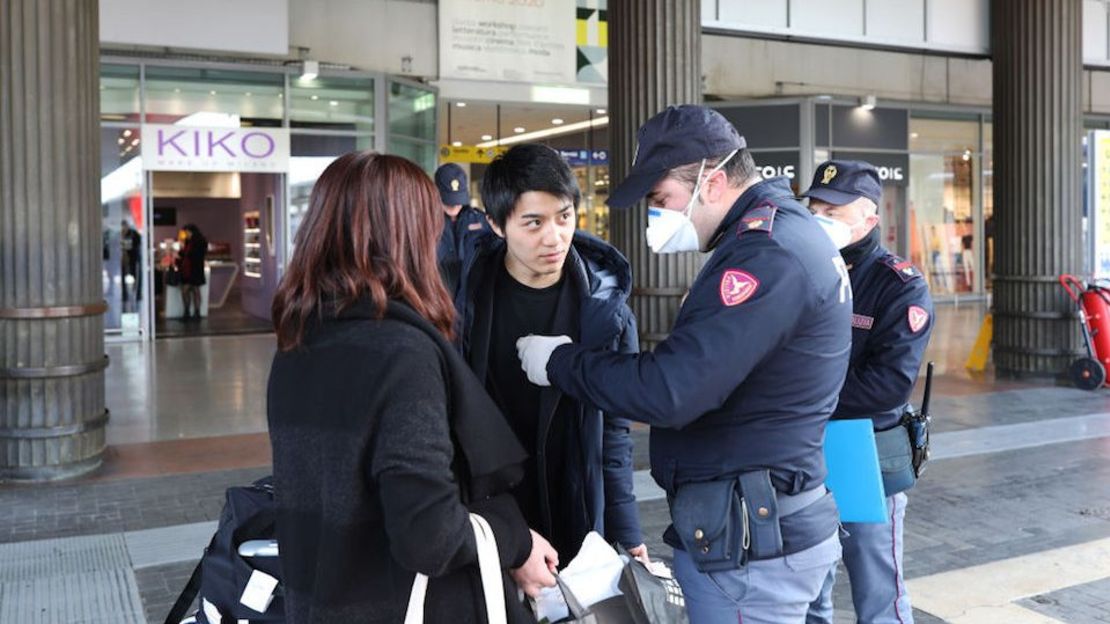 Policías realizan controles a ciudadanos y turistas en la estación de tren de Venecia Santa Lucía, para asegurarse de que no están violando la cuarentena, antes de subir a los trenes para salir de la ciudad.