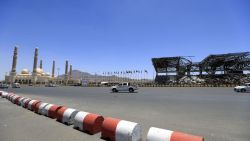 Vehicles drive past a popular public square, which was destroyed late 2017 in an airstrike by the Saudi-led coalition, in the capital Sanaa on April 9, 2020. - The Saudi-led coalition began a unilateral ceasefire in Yemen's long war, saying it hoped the initiative to prevent coronavirus in the impoverished country would lead to a wider political solution. (Photo by MOHAMMED HUWAIS / AFP)