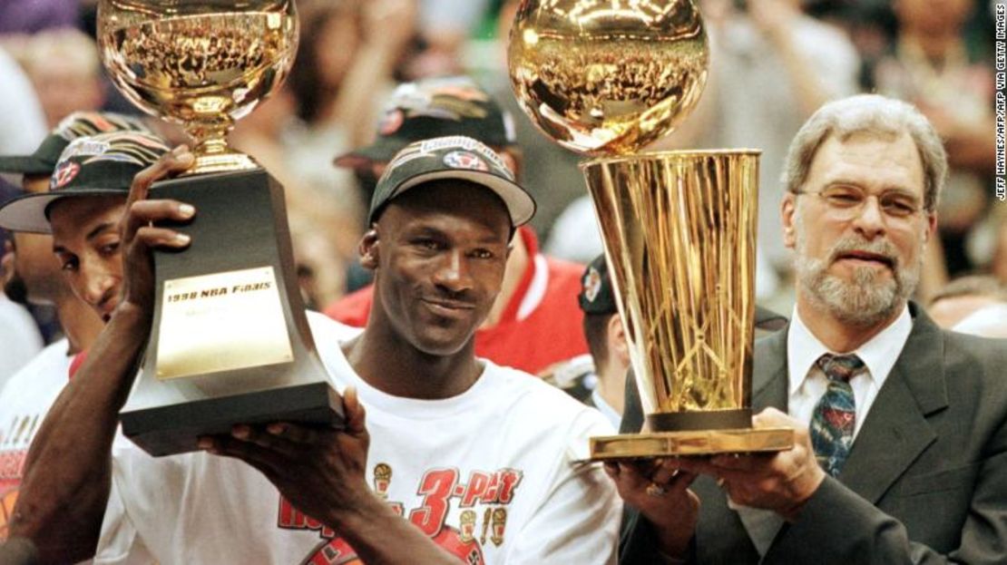 Jordan, visto aquí con Phil Jackson, levanta su trofeo de MVP de las Finales de la NBA.