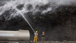 Firefighters work to put out a fire that has been burning for four days now at the Duquesa landfill in Santo Domingo on May 2, 2020. - The fire is the second to occur in less than a month and is attributed to the high temperatures in the area, combined with gas generated by the waste. (Photo by Erika SANTELICES / AFP)