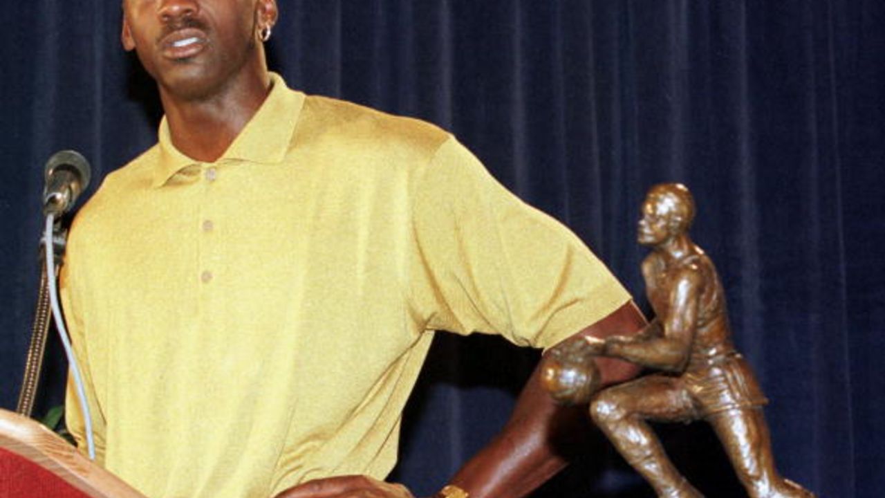 NORTHBROOK, UNITED STATES:  Michael Jordan (R) of the Chicago Bulls addresses the media as his fifth Maurice Podoloff Most Valuable Player Trophy for the 1997-98 season sits next to him18 May at a press conference at the Sheraton North Shore Hotel in Northbrook, IL. Jordan is trying to lead the Bulls to their sixth NBA title.  AFP PHOTO/Jeff HAYNES