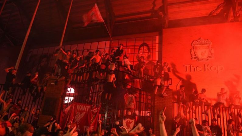 Los fanáticos celebran que Liverpool ganó el título de la Liga Premier afuera del estadio Anfield en Liverpool, noroeste de Inglaterra.