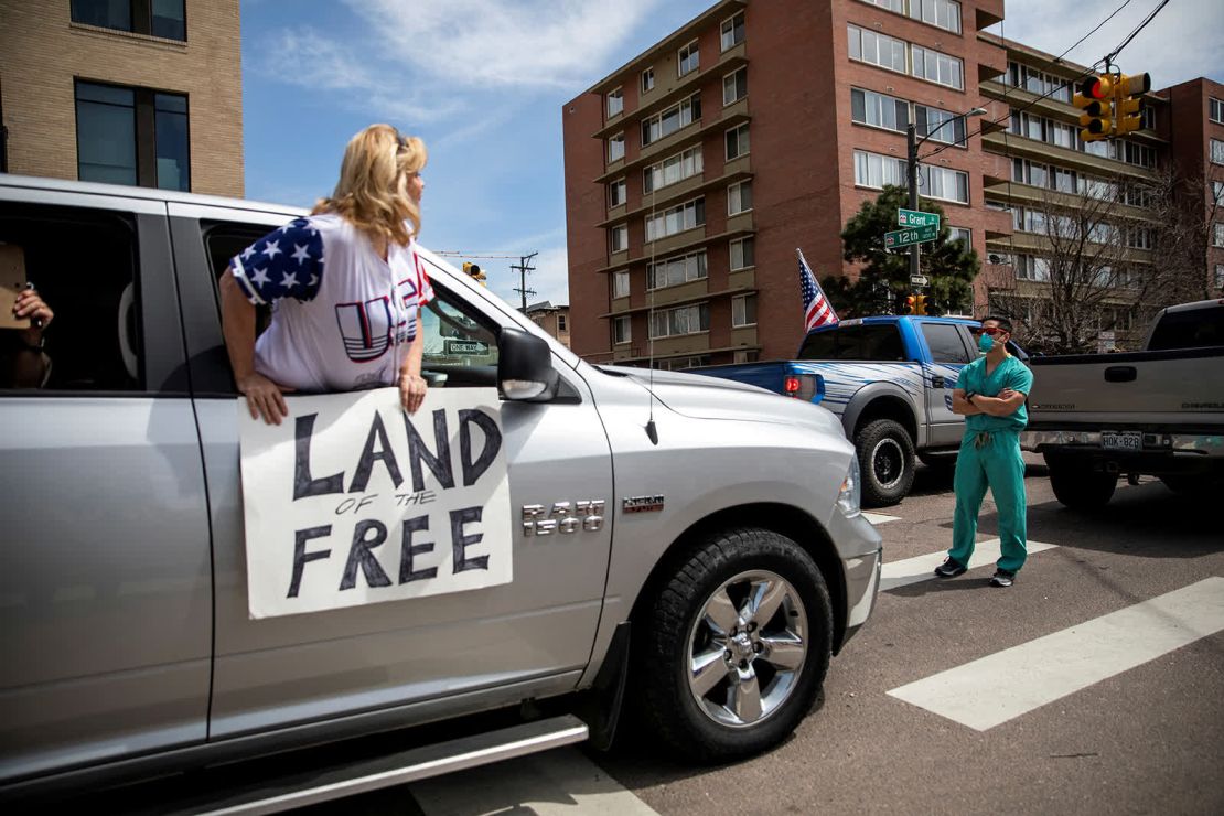 Un trabajador de la salud se para en una calle de Denver el 19 de abril, manifestándose en contra de una protesta en la que la gente pedía que se levantaran las órdenes de confinamiento. Manifestantes de todo el país han protestado contra las restricciones a raíz del coronavirus y se han quejado de que infringen sus libertades personales y amenazan con destruir sus medios de vida (Alyson McClaran/Reuters).