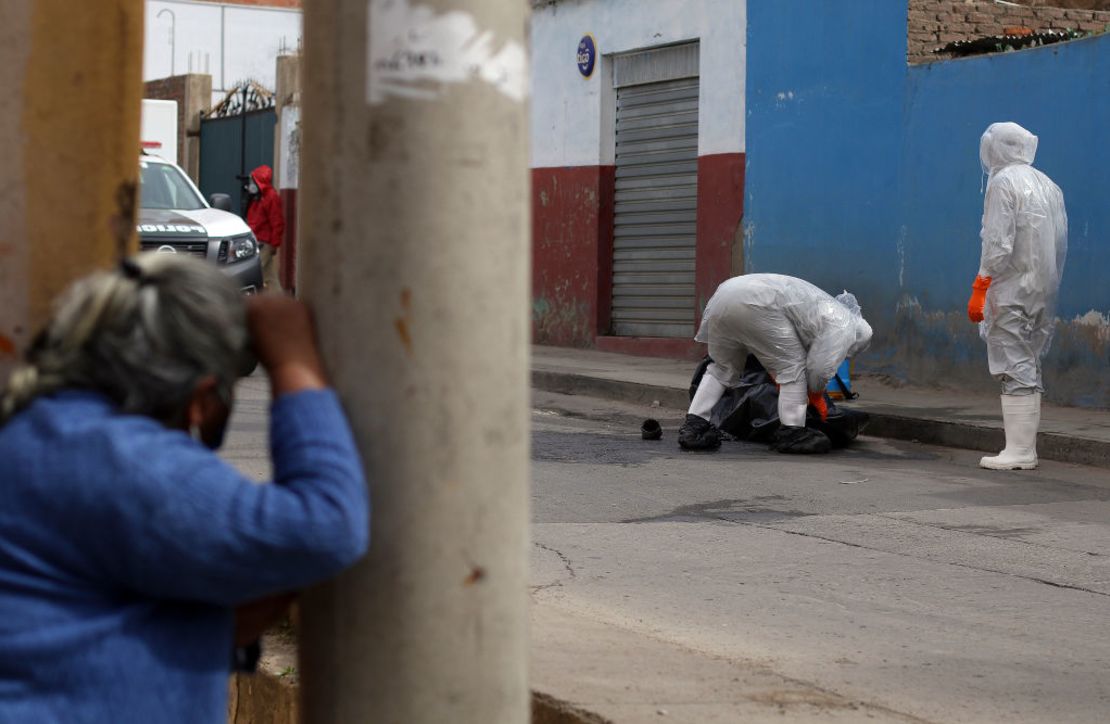 Trabajadores médicos recogen el cuerpo de una presunta víctima de covid-19 en Cochabamba, Bolivia.