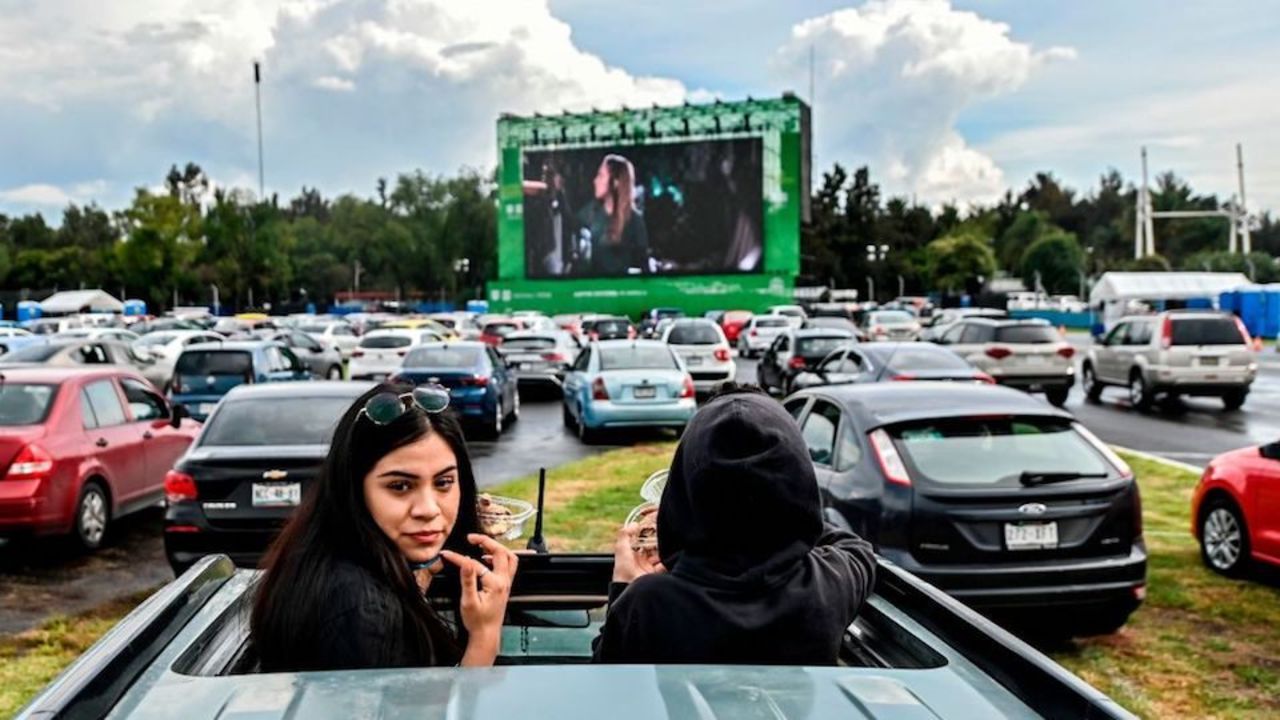 People attend a drive-in cinema set up at the Hermanos Rodriguez racetrack in Mexico City, on July 26, 2020, amid the novel coronavirus pandemic. (Photo by PEDRO PARDO / AFP)