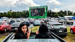 People attend a drive-in cinema set up at the Hermanos Rodriguez racetrack in Mexico City, on July 26, 2020, amid the novel coronavirus pandemic. (Photo by PEDRO PARDO / AFP)