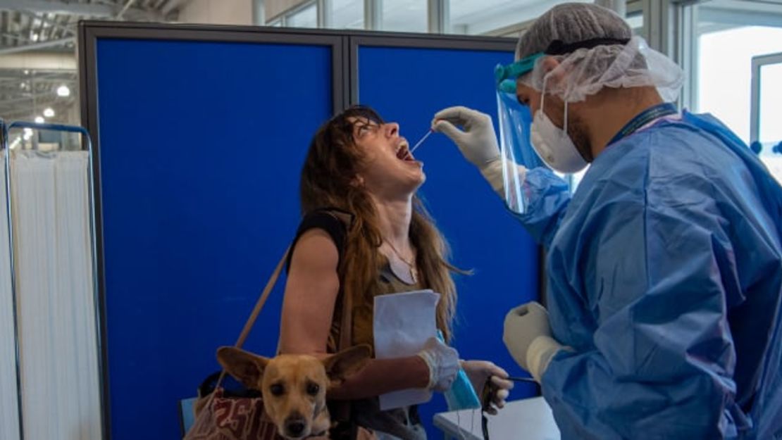 CNNE 877779 - covid-testing---travelers-are-tested-at-eleftherios-venizelos-international-airport---getty-images