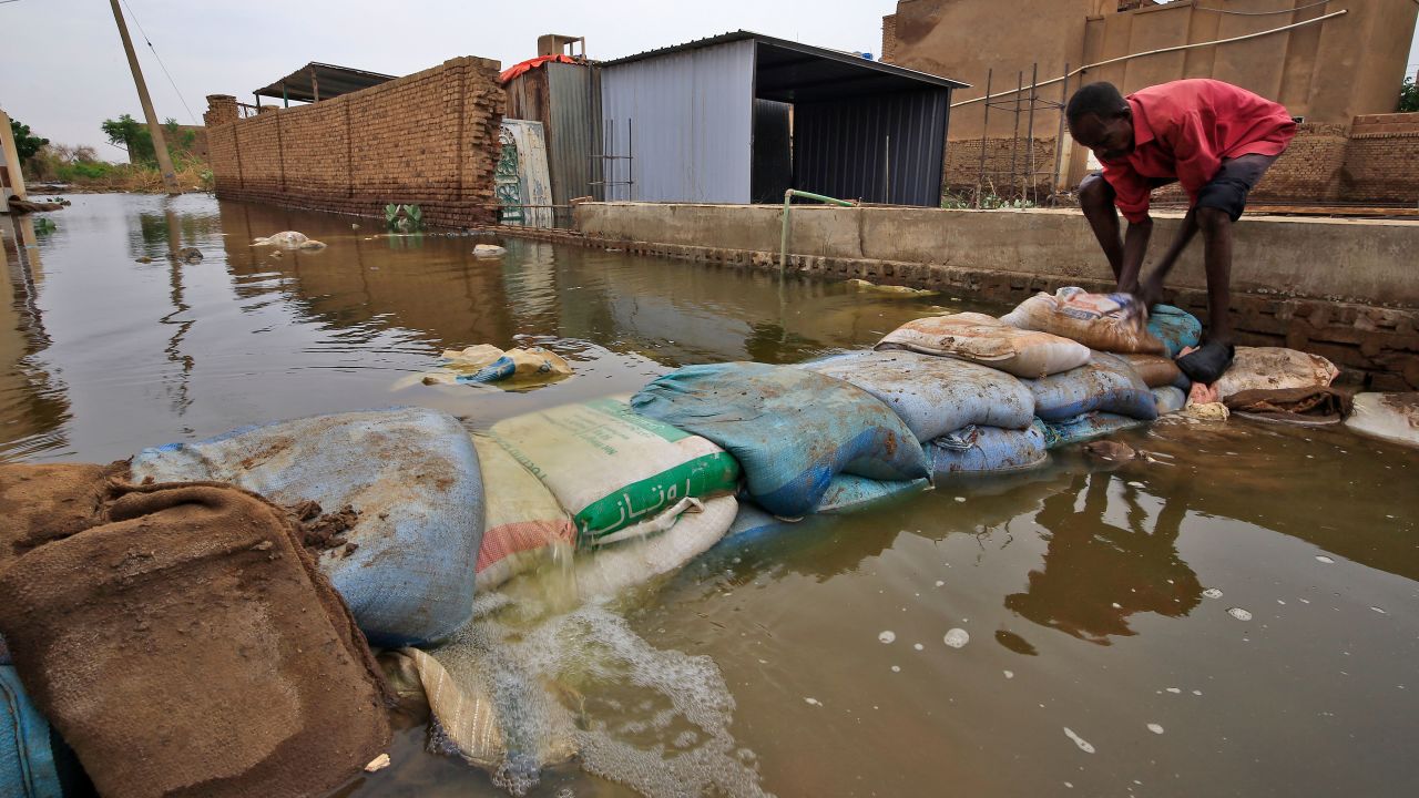 A Sudanese man build a barricade amidst flood waters in Tuti island, where the Blue and White Nile merge between the twin cities of the capital Khartoum and Omdurman, on September 3, 2020. - On Tuti Island, the highest Nile waters since records began a century ago have left people struggling to build dams by filling bags with sand and small stones to stem the flood. Officials say that across Sudan seasonal floods have killed 94 people, injured 46 and destroyed or damaged over 60,000 homes, with the river level rising to 17.43 metres (57 feet feet). (Photo by ASHRAF SHAZLY / AFP)