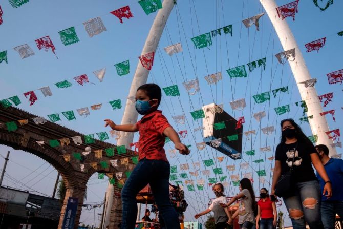 Gente en las calles decoradas de la Plaza Santa Cecilia en Tijuana.