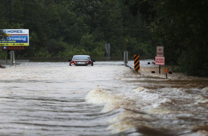 Un vehículo transita por una carretera inundada en Pensacola, Florida, tras el paso de Sally el 16 de septiembre de 2020.