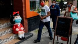 A statue depicting Mafalda of the comic strip character created by Argentinian cartoonist Joaquin Salvador Lavado, known as Quino, is seen at a restaurant in Mexico City, on September 30, 2020, on the day of his death. - Quino passed away Wednesday at 88, his editor confirmed, amid the COVID-19 novel coronavirus pandemic. (Photo by PEDRO PARDO / AFP)