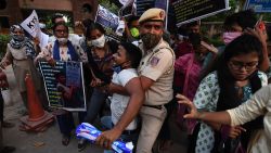 A Police personnel detains a student during a protest following accusations of Indian Police forcibly cremating the body of a 19-year-old woman victim, who was allegedly gang-raped by four men in Bool Garhi village of Uttar Pradesh state, outside the Delhi University (DU) campus in New Delhi on October 1, 2020. - Indian police were accused on September 30 of forcibly cremating the body of a 19-year-old alleged gang-rape victim as anger grew over the latest horrific sexual assault to rock the country. The teenager from India's marginalised Dalit community suffered serious injuries in a brutal sexual attack two weeks ago, according to her family and police, and died at a New Delhi hospital on September 29. (Photo by Sajjad HUSSAIN / AFP)