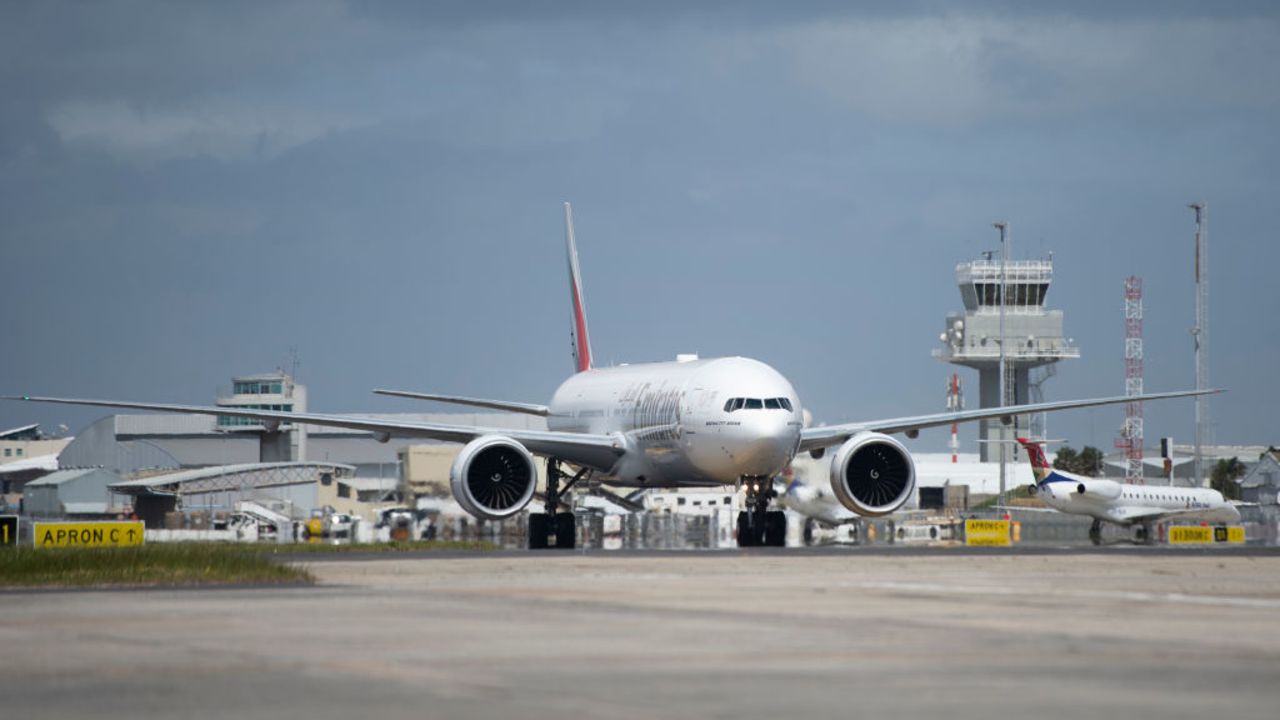 An Emirates aircraft taxi's after landing at the Cape Town International airport after flying from Dubai, one of the first international commercial flights coming into South Africa, in Cape Town on October 1, 2020. - A first batch of regional and international flights landed in South Africa on October 1, 2020, as borders reopened after a more than six-month shutdown to limit the spread of coronavirus (Photo by RODGER BOSCH / AFP)