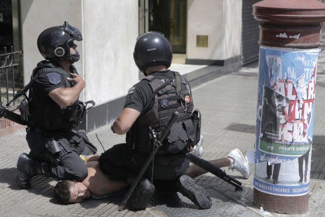 La policía antidisturbios detiene a un seguidor de Maradona durante los enfrentamientos en su velatorio el 26 de noviembre de 2020 en Buenos Aires, Argentina.