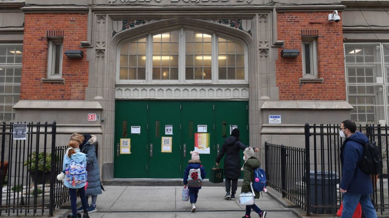 Children arrive for class on the first day of school reopening on December 7, 2020 in the Brooklyn borough of New York City. - The novel coronavirus has killed at least 1,535,987 people since the outbreak emerged in China last December, according to a tally from official sources compiled by AFP at 1100 GMT on Monday. The US is the worst-affected country with 282,324 deaths. (Photo by Angela Weiss / AFP)