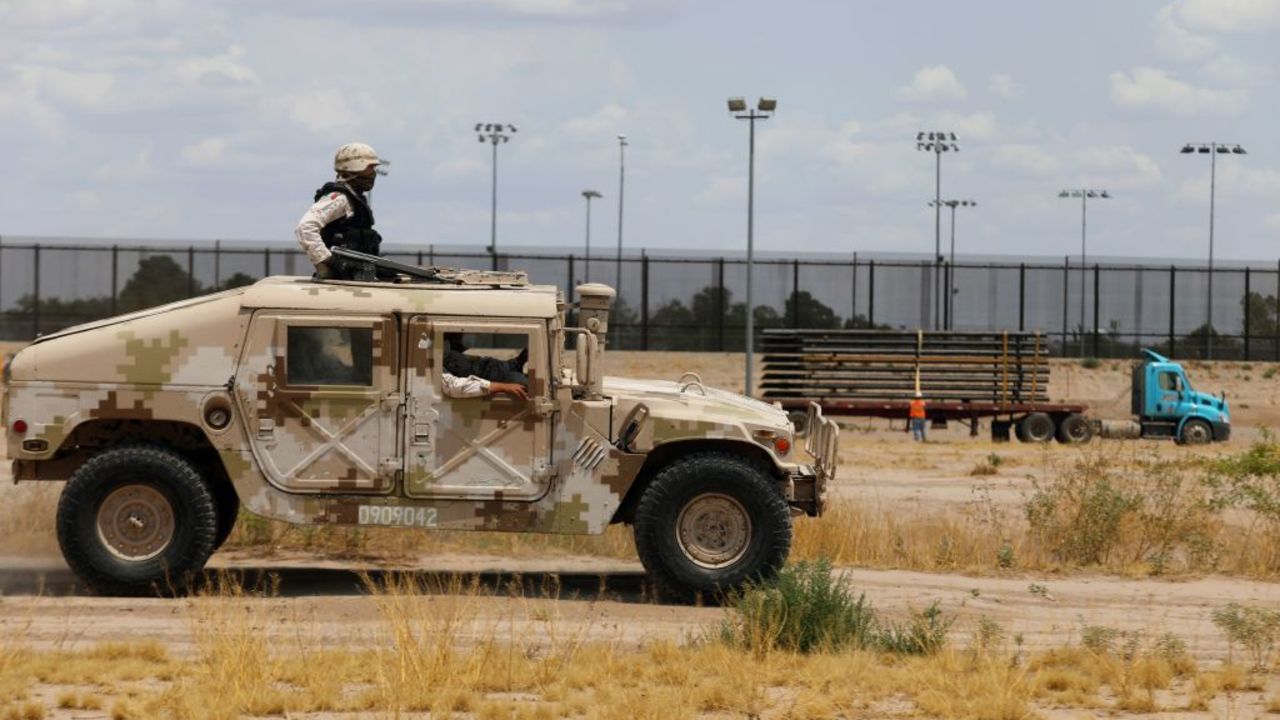 Members of the Mexican National Guard patrol along the banks of the Rio Grande (dry) by the construction site of a new section of the border wall between the US city of El Paso, Texas and Ciudad Juarez, Chihuahua state, Mexico on August 17, 2020. (Photo by HERIKA MARTINEZ / AFP)