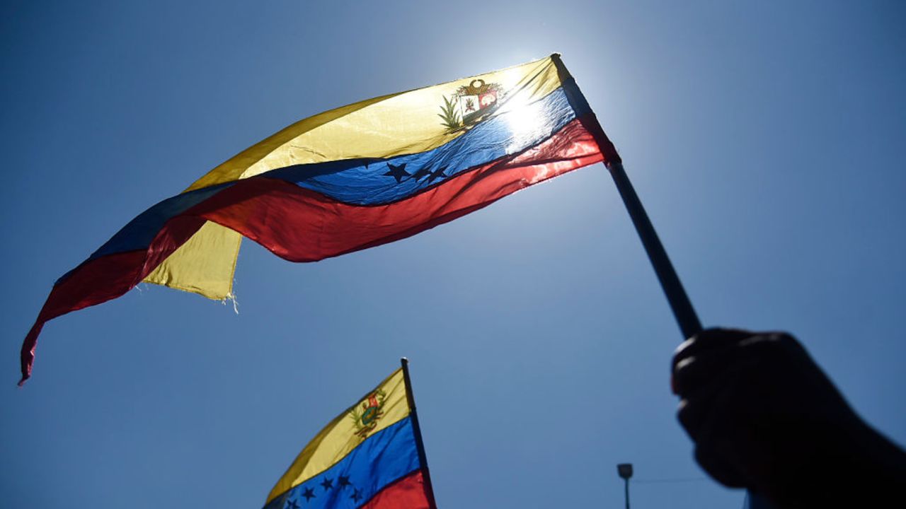 CARACAS, VENEZUELA - JANUARY 23:  Demonstrators hold  Venezuelan flags during a demonstration against imperialism organized by governing party PSUV (Socialist Party of Venezuela) at Catia district on January 23, 2020 in Caracas, Venezuela.