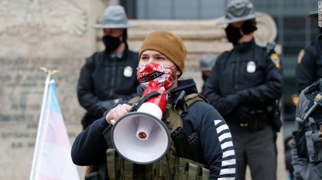 Un manifestante armado se para el domingo frente a la policía estatal frente a la Cámara de Representantes de Ohio en Columbus.