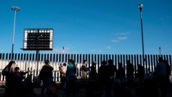 Asylum seekers wait for their turn to cross  to the United States at El Chaparral crossing port on the US/Mexico Border in Tijuana, Baja California state, Mexico, on February 29, 2020. . - Migrant Protection Protocols, better known as the 'Remain in Mexico Policy', was blocked by the United States Court of Appeals for the Ninth Circuit, seeming to halt a policy which drastically reduced the amount of border crossings. However, the court later granted the Trump Administration a stay on the program, for fear of creating an influx on the southern border (Photo by Guillermo Arias / AFP)