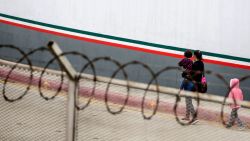 TOPSHOT - A Central American migrant and her children walk outside El Chaparral port of entry, in Tijuana, Baja California state, Mexico, on July 17, 2019. (Photo by OMAR MARTÍNEZ / AFP)