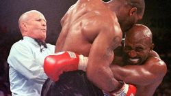 LAS VEGAS, UNITED STATES:  Referee Lane Mills (L) steps in as Evander Holyfield (R) reacts after Mike Tyson bit his ear in the third round of their WBA heavyweight championship fight at the MGM Grand Garden Arena in Las Vegas, NV 28 June. Holyfield won by disqualification after the biting incident.     AFP PHOTO/JEFF HAYNES