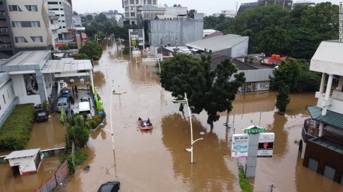 Esta imagen aérea muestra a personas remando en una balsa sobre una carretera inundada en Yakarta, el 20 de febrero de 2021, luego de las fuertes lluvias nocturnas. La combinación de tanta gente y la multitud de ríos ha hecho que esta ciudad sea especialmente propensa a un aumento relativo del nivel del mar.