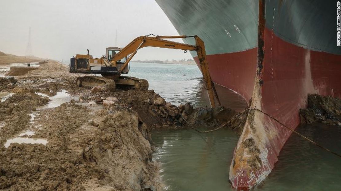 Una excavadora intenta liberar la parte delantera del Ever Given.