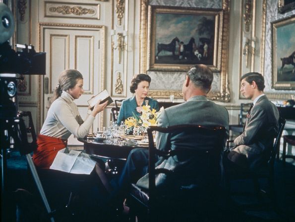 La reina Isabel II almuerza con el príncipe Felipe y sus hijos, la princesa Ana y el príncipe Carlos en el castillo de Windsor en Berkshire, alrededor de 1969. Una cámara (a la izquierda) se ubica para grabar el documental de la BBC Royal Family', de Richard Cawston. La producción siguió a la familia real durante un año y se transmitió el 21 de junio de 1969.