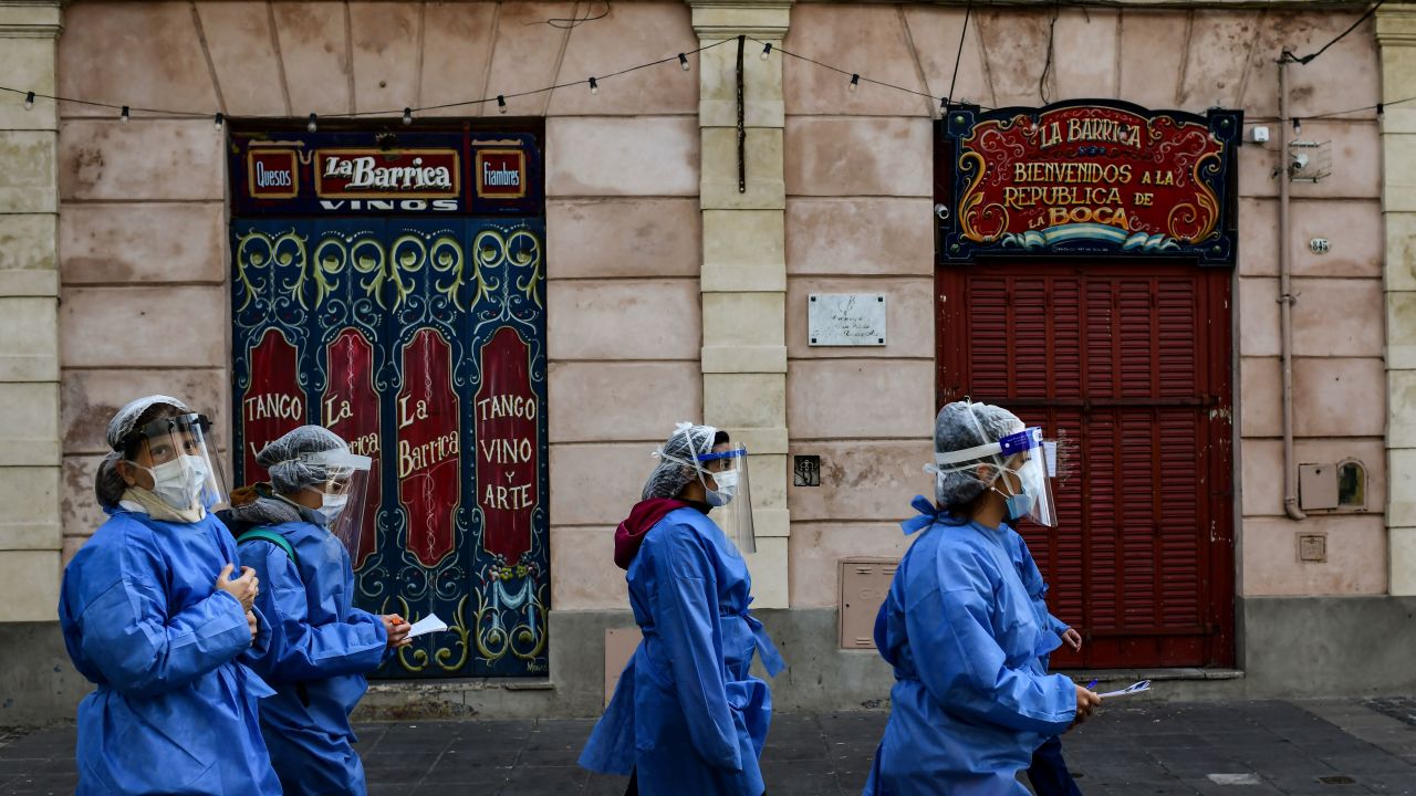 Women health workers walk at Caminito street after visiting people suspected of having COVID-19 at La Boca neighbourhood in Buenos Aires, on July 9, 2020 amid the new coronavirus pandemic. - Buenos Aires' La Boca neighbourhood has been hit hard by the lack of tourists due to the pandemic. (Photo by Ronaldo SCHEMIDT / AFP)