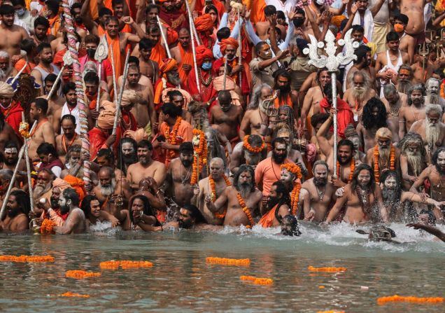 Hombres hindúes se adentran en el río Ganges durante el festival religioso Kumbh Mela el 12 de abril. La gente también llenó las calles de Haridwar para lo que es la peregrinación religiosa más grande de la Tierra, y las multitudes masivas generaron preocupación. Karma Sonam / AP