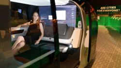 LONDON, ENGLAND - MAY 09:  A gallery assistant sits inside the "Sedric" Volkswagen driverless concept car during the press launch of the new exhibition; "The Future Starts Here" at Victoria and Albert Museum on May 9, 2018 in London, England.  Running from May 12 to November 4 2018, the exhibition brings together ground-breaking technologies and designs currently in development around the world.