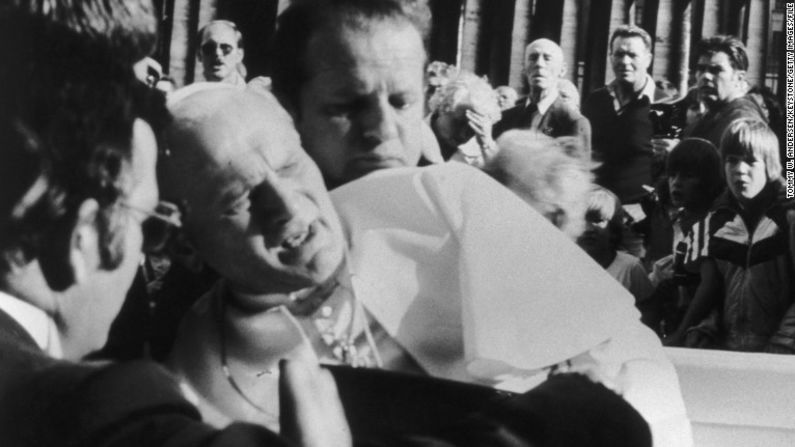 Juan Pablo II fue herido de bala en el abdomen, el abrazo y la mano, mientras se desplazaba a través de la Plaza De San Pedro, en Roma. En esta foto sus guardaespaldas lo sostienen y le brindan auxilio tras el atentado.