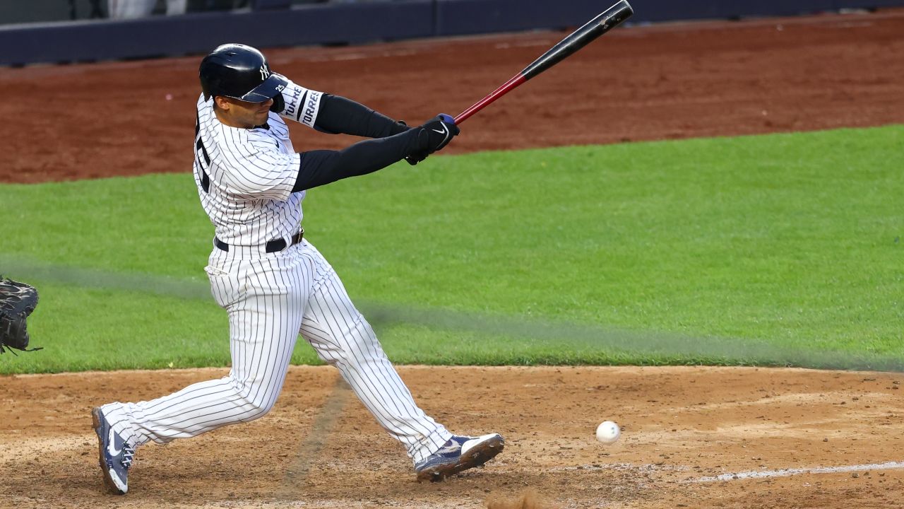 NEW YORK, NY - MAY 08: Gleyber Torres #25 of the New York Yankees hits a soft roundball for an infield single that scored DJ LeMahieu #26 for the winning run in the 11th inning of a game against the Washington Nationals at Yankee Stadium on May 8, 2021 in New York City. The Yankees defeated the Nationals 4-3.