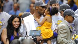 Kobe Bryant of the Los Angeles Lakers celebrates victory with his family following Game 5 of the NBA Finals against the Orlando Magic at Amway Arena on June 14, 2009 in Orlando, Florida. The Lakers won the National Basketball Association championships defeating Orlando 99-86 for their 15th title and first since 2002. Series MVP Bryant had 30 points, eight rebounds and six assists as the Lakers completed a four-games-to-one victory in the best-of-seven NBA Finals.   AFP PHOTO / Stan Honda (Photo by STAN HONDA / AFP)