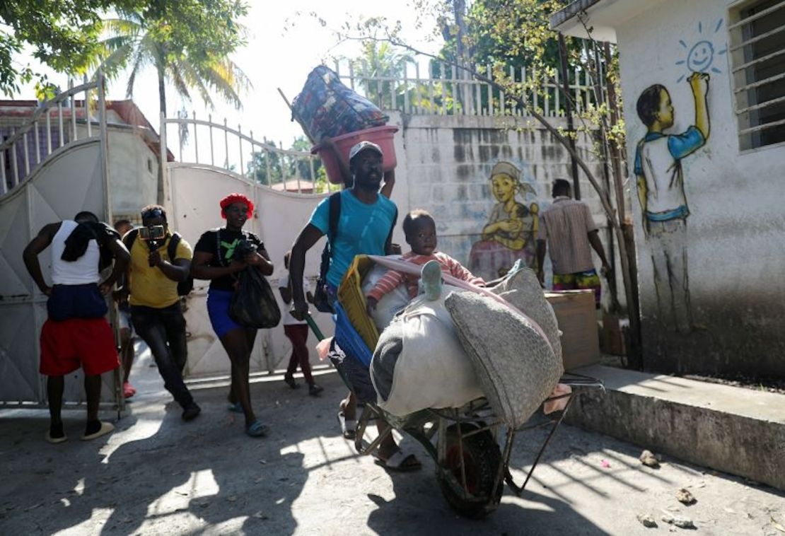 Varias personas llegan con sus pertenencias a un refugio huyendo de la violencia en torno a sus hogares, en Puerto Príncipe, Haití, 9 de marzo de 2024.