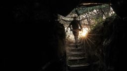 A Ukrainian servicemember carries a shell before firing towards Russian troops near the frontline town of Chasiv Yar, in Ukraine's Donetsk region, on June 14.