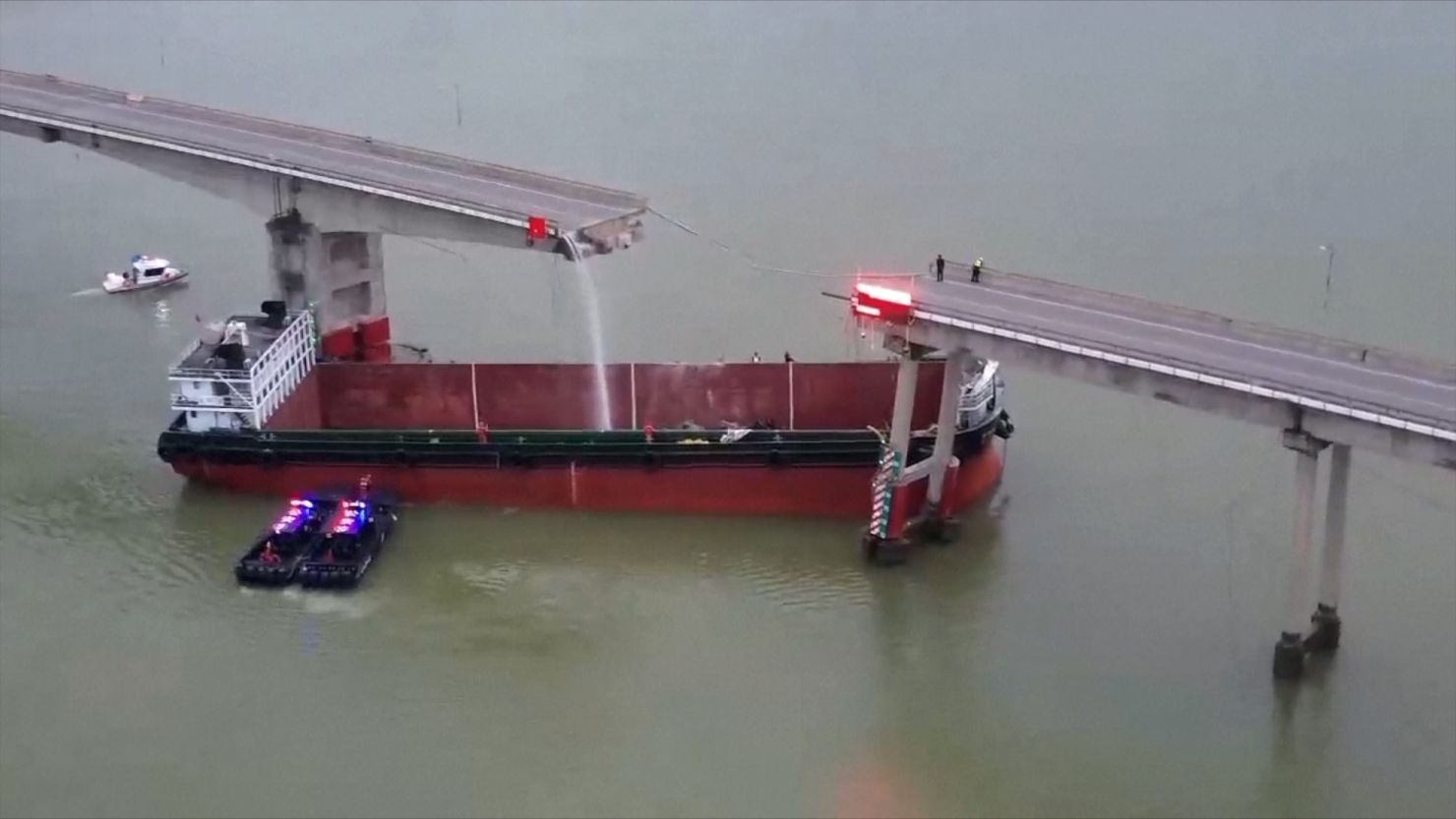 An empty cargo ship is shown lodged under the fractured Lixinsha Bridge on February, 22, 2024.