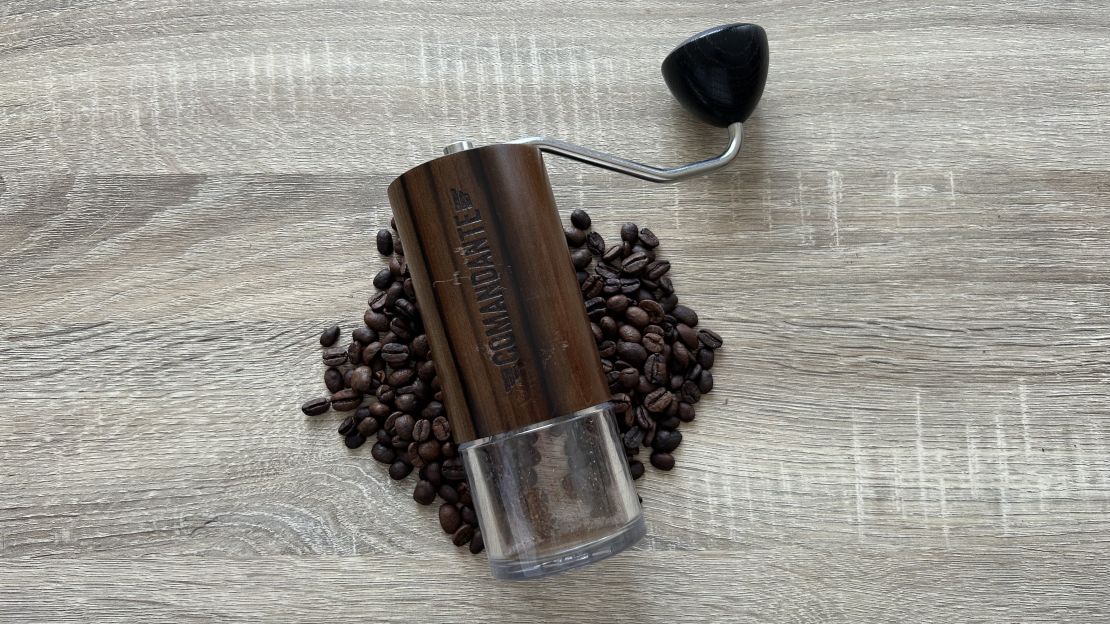 Comandante C40 MK4 coffee grinder on a bed of coffee beans