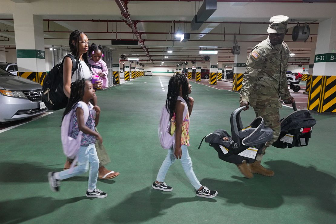 US Army Sgt. Terry Cook and his wife, Tyrese, walk with their five children to their new home in Korea, Camp Humphreys.