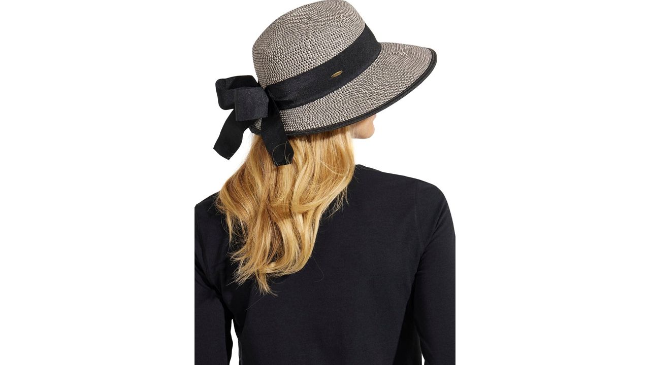 A photo of a person wearing the Coolibar Perla Packable Wide Brim Hat